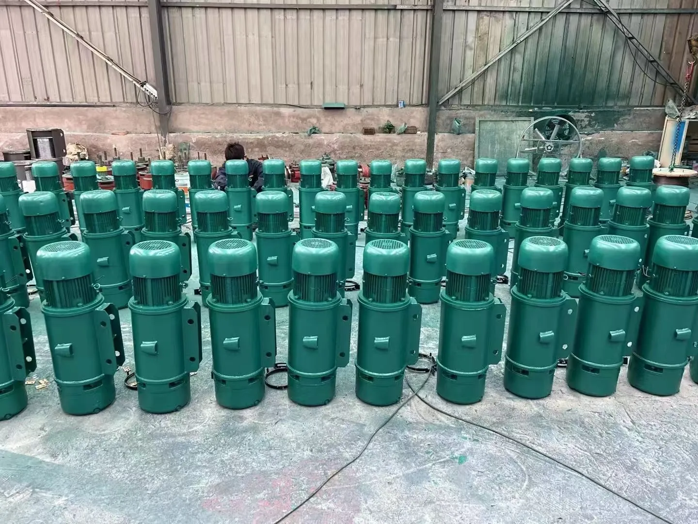 Hoist motors staged on the workshop floor