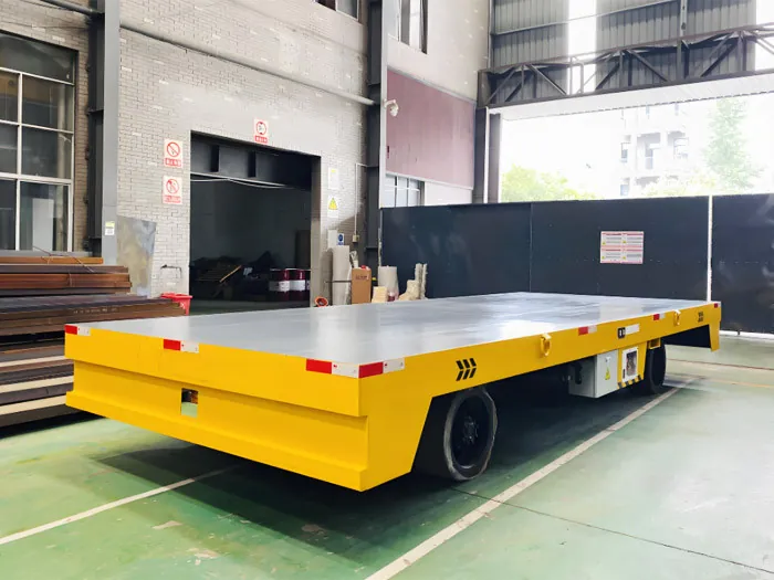 Trackless electric transfer cart on rubber wheels with a large flat deck